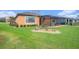Lush green backyard features mature landscaping and serene views of pond at 13305 Fawn Lily Dr, Riverview, FL 33579