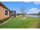 Picturesque backyard showcases lush lawn, pond views, and an inviting screened-in lanai at 13305 Fawn Lily Dr, Riverview, FL 33579