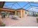 Expansive backyard with a screened-in lanai and a view of a tranquil pond at 13305 Fawn Lily Dr, Riverview, FL 33579