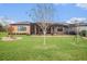 Lush green backyard features mature landscaping and serene views of pond at 13305 Fawn Lily Dr, Riverview, FL 33579