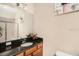 Well-lit bathroom features a single sink vanity with a large mirror and a glass-enclosed shower at 13305 Fawn Lily Dr, Riverview, FL 33579