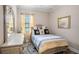 Bedroom featuring a large mirror, a picture window, and ample lighting at 13305 Fawn Lily Dr, Riverview, FL 33579
