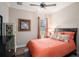 Cozy bedroom with neutral paint, wood floors, ample lighting, and large window at 13305 Fawn Lily Dr, Riverview, FL 33579