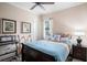 Stylish bedroom with hardwood floors, piano, and a large window at 13305 Fawn Lily Dr, Riverview, FL 33579