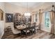 Beautiful dining room featuring hardwood floors, elegant light fixture, and decorative accents at 13305 Fawn Lily Dr, Riverview, FL 33579