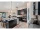 Bright kitchen with stainless steel appliances, granite counters, island, and modern pendant lighting at 13305 Fawn Lily Dr, Riverview, FL 33579