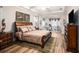 Spacious main bedroom featuring tray ceiling, wood floors, neutral walls, and ample natural light at 13305 Fawn Lily Dr, Riverview, FL 33579