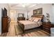 Spacious main bedroom featuring tray ceiling, wood floors, neutral walls, and ample natural light at 13305 Fawn Lily Dr, Riverview, FL 33579