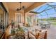 Inviting covered patio with comfortable seating, fan and view of the lake at 13305 Fawn Lily Dr, Riverview, FL 33579
