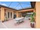 Covered patio boasts an outdoor dining area and lounge seating, perfect for entertaining at 13305 Fawn Lily Dr, Riverview, FL 33579