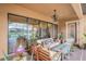 Inviting covered patio with comfortable seating, fan and view of the lake at 13305 Fawn Lily Dr, Riverview, FL 33579