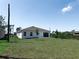 Wide shot of a home's newly seeded backyard at 134 Jade St, Rotonda West, FL 33947