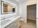 Modern bathroom with double sinks, lighted mirror, and walk-in closet at 134 Jade St, Rotonda West, FL 33947