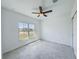 Bedroom featuring tile flooring, a ceiling fan, and a large window at 134 Jade St, Rotonda West, FL 33947