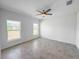 Bright bedroom with neutral walls, tiled floor and a ceiling fan at 134 Jade St, Rotonda West, FL 33947