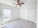 Bright bedroom with tiled floor, ceiling fan and closet with sliding doors at 134 Jade St, Rotonda West, FL 33947