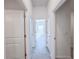 Hallway with tiled flooring with doors open to different rooms in the home at 134 Jade St, Rotonda West, FL 33947