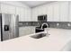 Bright kitchen showcasing stainless steel appliances, sleek countertops, and modern cabinets with ample storage at 134 Jade St, Rotonda West, FL 33947