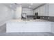 Beautiful kitchen features a large island with a quartz countertop, stainless steel appliances and white cabinets at 134 Jade St, Rotonda West, FL 33947