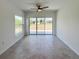 Bright living room with large windows and sliding glass doors leading to the backyard at 134 Jade St, Rotonda West, FL 33947