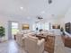 Spacious living room with ample seating, natural light, and tiled flooring at 134 Jade St, Rotonda West, FL 33947