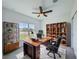 Well-lit office space with a large desk, shelving, and a comfortable chair at 134 Jade St, Rotonda West, FL 33947
