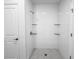 Elegant walk-in shower with modern fixtures and white tiled walls at 134 Jade St, Rotonda West, FL 33947