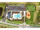 Aerial of community amenities including a pool, clubhouse, playground, dog park and parking area at 17069 Moonflower Dr, Venice, FL 34293