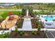 Aerial view showcasing the playground, pool, and recreation area with pathways and landscaping at 17069 Moonflower Dr, Venice, FL 34293