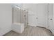 Bathroom showcases walk-in shower with glass enclosure, bench, and tiled walls at 17069 Moonflower Dr, Venice, FL 34293