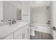 Bathroom featuring vanity with stone countertop, framed mirror, tub and shower combo at 17069 Moonflower Dr, Venice, FL 34293