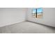 Bright bedroom offers a large window with natural light and neutral carpeting at 17069 Moonflower Dr, Venice, FL 34293