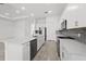 Modern kitchen featuring an island with sink, stainless steel appliances, tile backsplash, and recessed lighting at 17069 Moonflower Dr, Venice, FL 34293