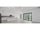 Bright, open-concept kitchen, dining and gathering room with modern finishes and tile flooring at 17069 Moonflower Dr, Venice, FL 34293