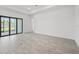 Bright living room boasts wood-style tile floor and sliding glass doors to lanai at 17069 Moonflower Dr, Venice, FL 34293