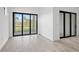Bright and airy living area with tile flooring and sliding glass doors, offering seamless indoor-outdoor living at 17069 Moonflower Dr, Venice, FL 34293
