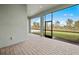 Screened porch boasts brick-style flooring and views of lush backyard at 17069 Moonflower Dr, Venice, FL 34293