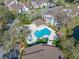 Aerial view of the sparkling community pool and spa, surrounded by manicured landscaping and lounging areas at 1735 Lake Cypress Dr, Safety Harbor, FL 34695