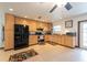 Well-lit kitchen featuring wooden cabinets, tile flooring, stainless steel appliances, and a window at 1875 Seton Dr, Clearwater, FL 33763