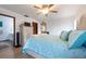 Main bedroom with light wood floors, dresser, ensuite bathroom, and view to the rest of the home at 1875 Seton Dr, Clearwater, FL 33763