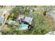 Birds-eye view of the house with pool, patio, mature trees, and verdant lawn at 215 Willowick Ave, Temple Terrace, FL 33617