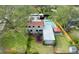 Aerial view of home with a pool, covered patio, and a lush green lawn at 215 Willowick Ave, Temple Terrace, FL 33617