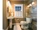 Modern bathroom featuring an enclosed glass shower, natural light, and a pedestal sink at 215 Willowick Ave, Temple Terrace, FL 33617