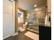 Modern bathroom featuring an enclosed glass shower, natural light, and black tile flooring at 215 Willowick Ave, Temple Terrace, FL 33617
