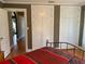 Bedroom featuring hardwood floors, white closets, and natural light from a doorway at 215 Willowick Ave, Temple Terrace, FL 33617