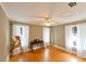 Bedroom featuring hardwood floors, white curtains, and natural light from the two windows at 215 Willowick Ave, Temple Terrace, FL 33617