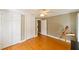 Bedroom featuring hardwood floors, white closets, and natural light from the two windows at 215 Willowick Ave, Temple Terrace, FL 33617