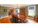 Spacious dining room with hardwood floors, a large table, and vintage built-in china cabinet at 215 Willowick Ave, Temple Terrace, FL 33617