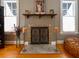 Close-up shot of the fireplace with a beautiful mantel display between two windows at 215 Willowick Ave, Temple Terrace, FL 33617