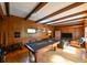 Recreational game room featuring a pool table, wood paneling, exposed beams, and hardwood flooring at 215 Willowick Ave, Temple Terrace, FL 33617